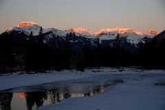 23 Mount Bourgeau, Mount Brett, Massive Mountain and Pilot Mountain Glow In The First Rays Of Sunrise From Bow River Bridge In Banff In Winter.jpg